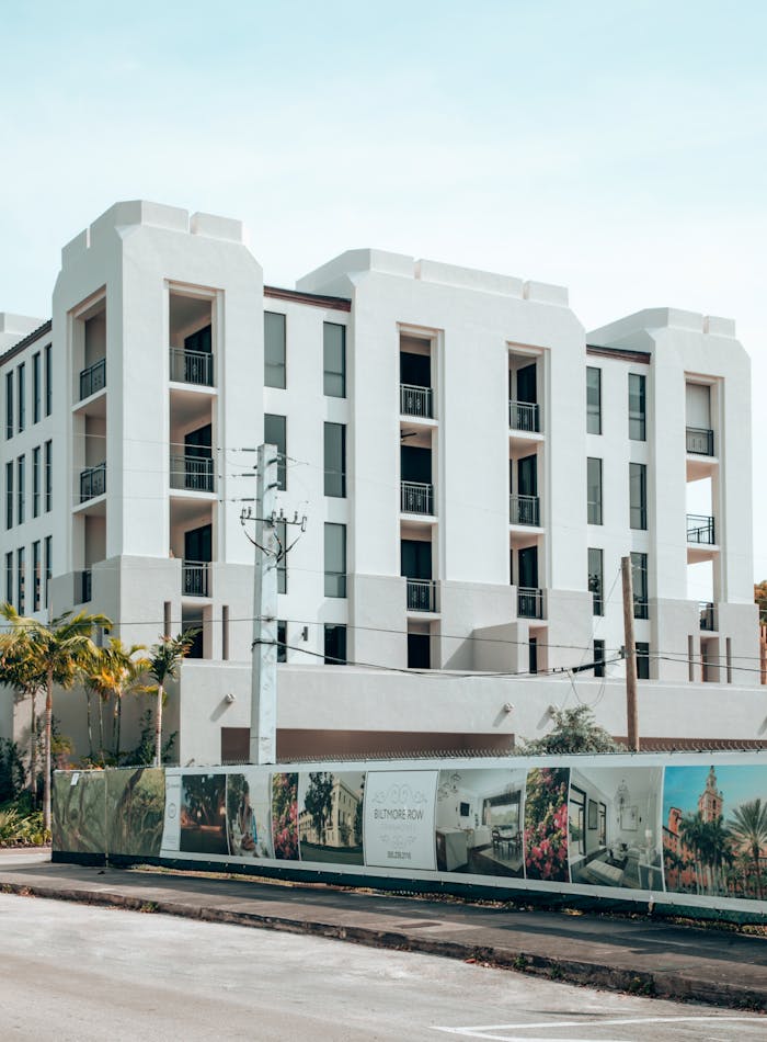 gallery-3 Elegant modern apartment building exterior in Coral Gables, Florida, under a clear blue sky.